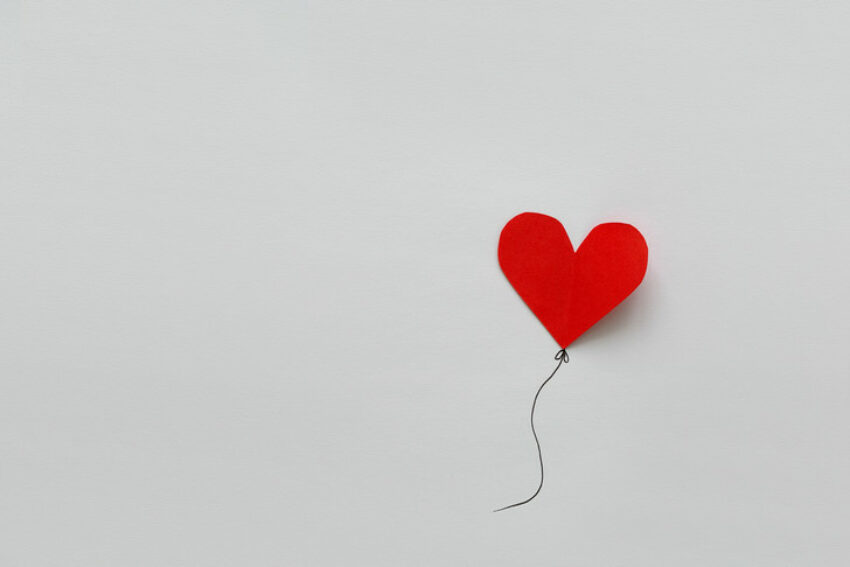 Valentines day card. Red paper heart shape balloons on thread. Paper cut style and minimalist concept